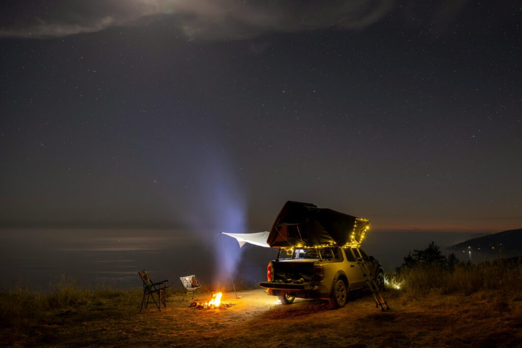 Night Camping with Vehicle Under Starry Sky